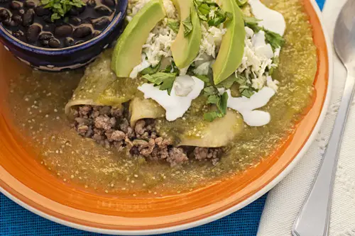 Green Enchiladas with Ground Beef served with beans