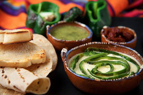 Melted Cheese with Peppers accompanied with breads and tortillas