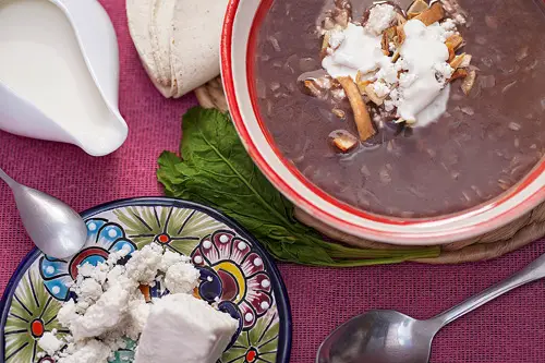 Black Bean Soup with cream, cheese and fried tortilla strips