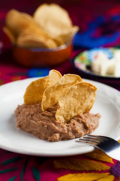 Refried Beans with tortilla chips, cheese and bread