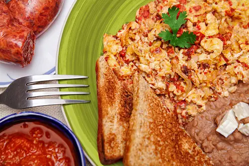 Scrambled Eggs with Chorizo served with beans and bread