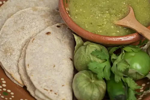 Tomatillo Salsa accompanied with tortillas